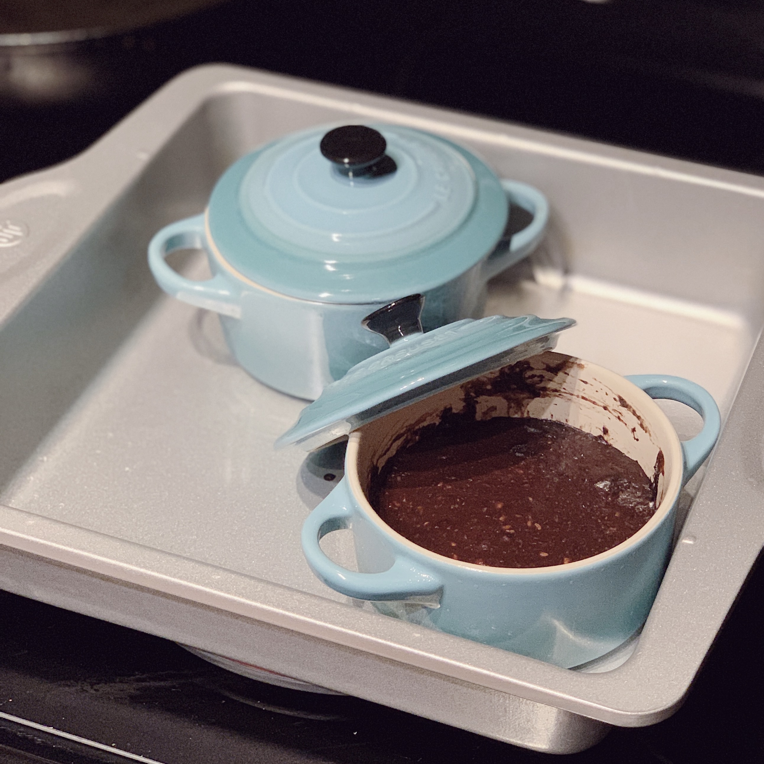 a photo of two small pot ramekins with a Mug Cake mixture