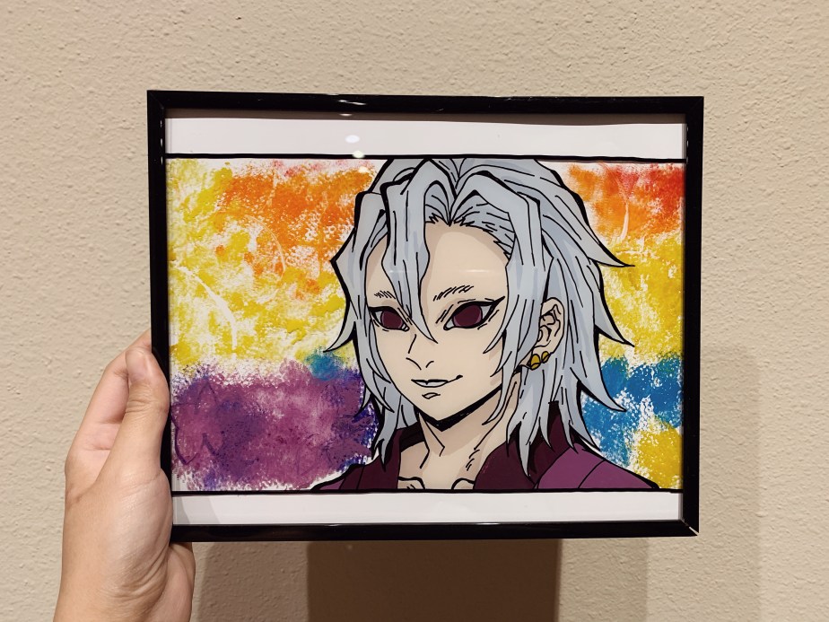 Siri Svay holding a black-framed glass painting of Tengen Uzui from Demon Slayer