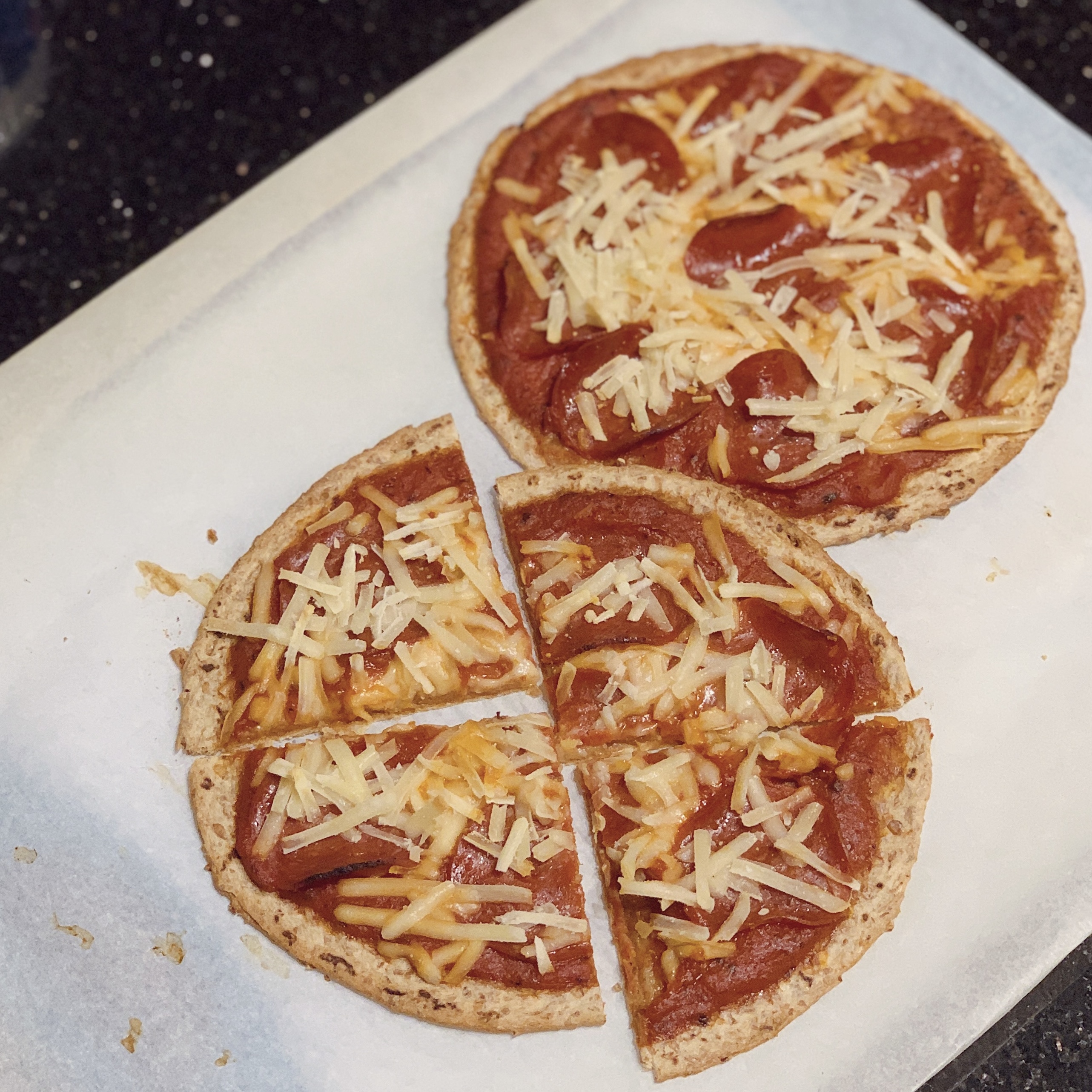 Two plant-based flatbread pizzas with plant-based cheese, pepperoni and vegan sauce.